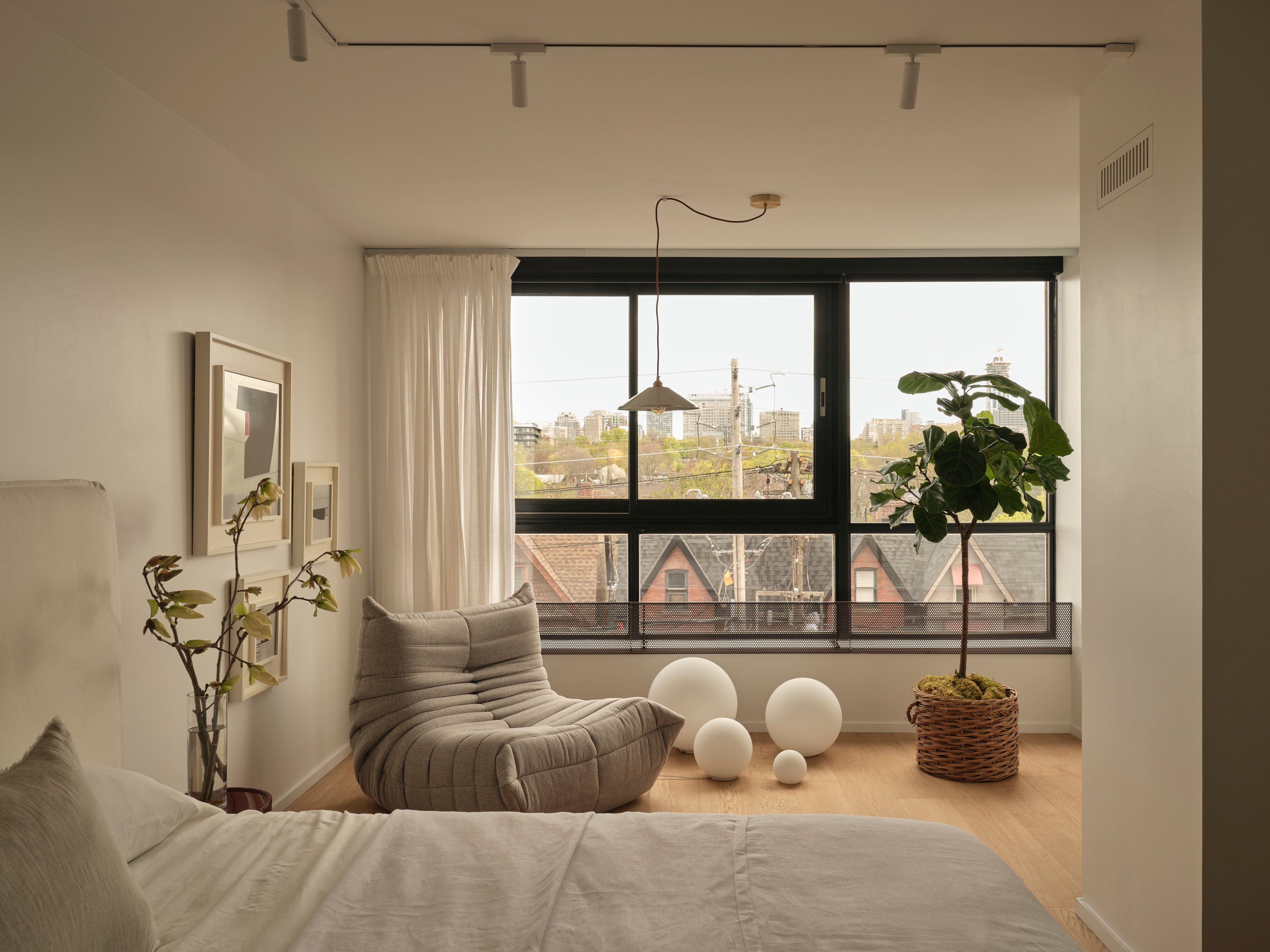 Renovated primary bedroom with white oak floors and black steel windows